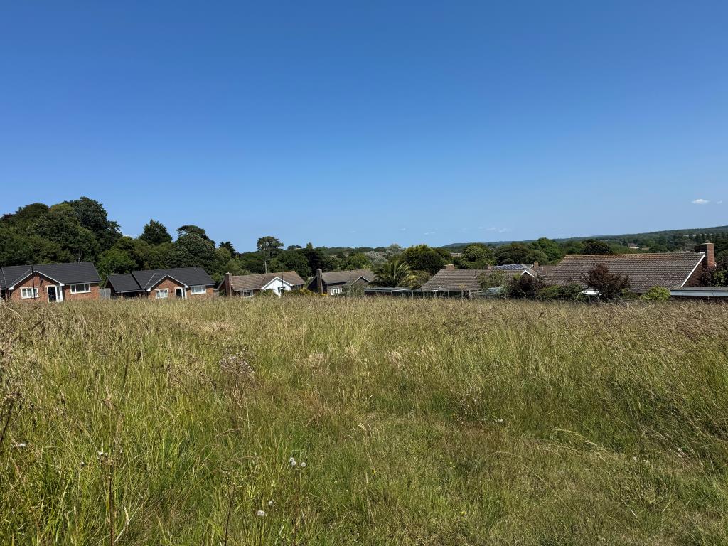 Lot: 33 - OVER THREE-QUARTERS OF AN ACRE FREEHOLD LAND WITH PLANNING FOR SEVEN DETACHED BUNGALOWS - Looking back Across the Site Towards the Most recently Built Bungalows